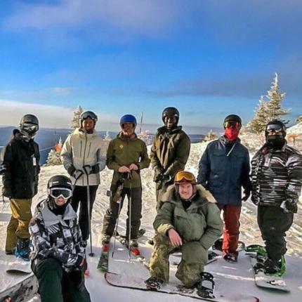 A group of graduate students posing before skiing and snowboarding